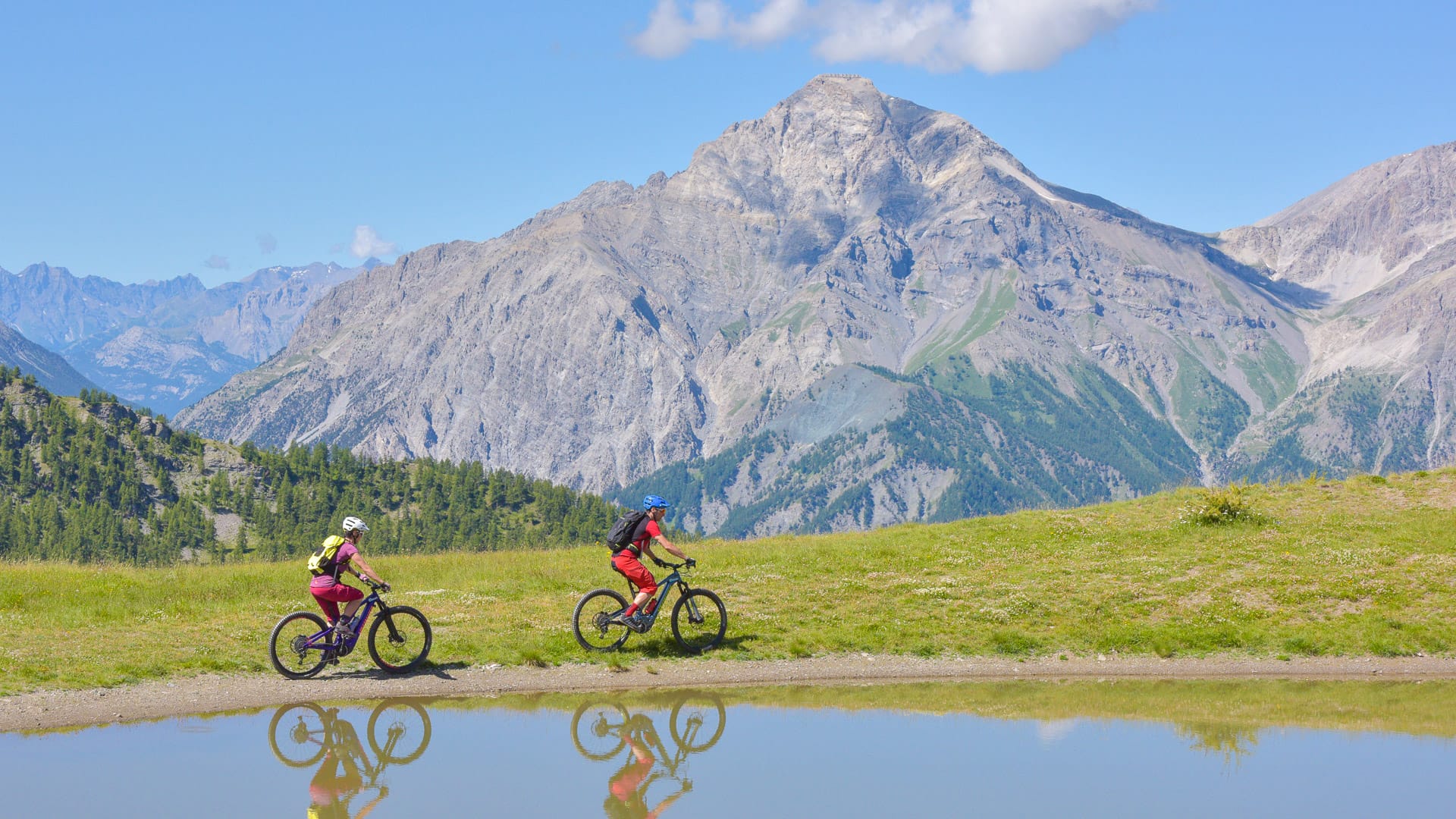 Cyclists riding through Sauze d'Oulx in the Piedmont Alps