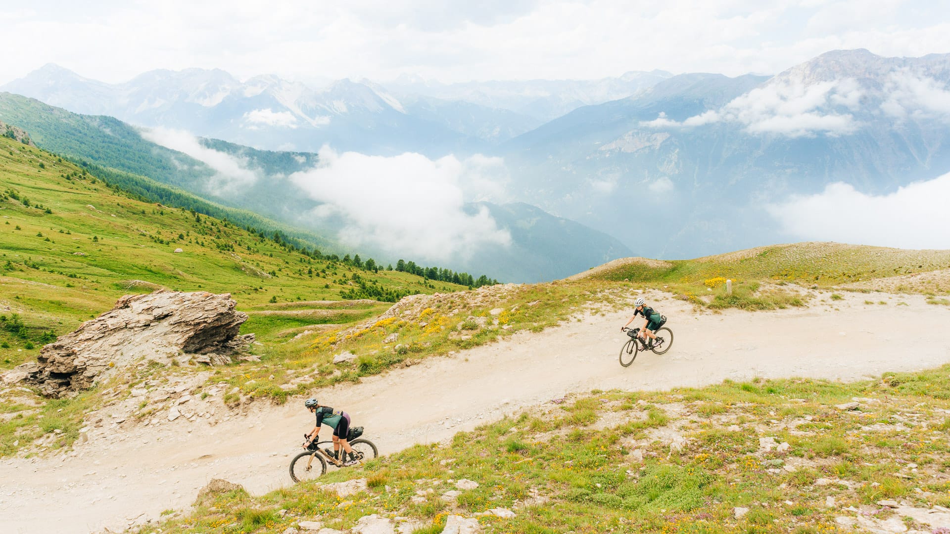 Cyclists riding along Strada dell'Assietta in the Piedmont Alps