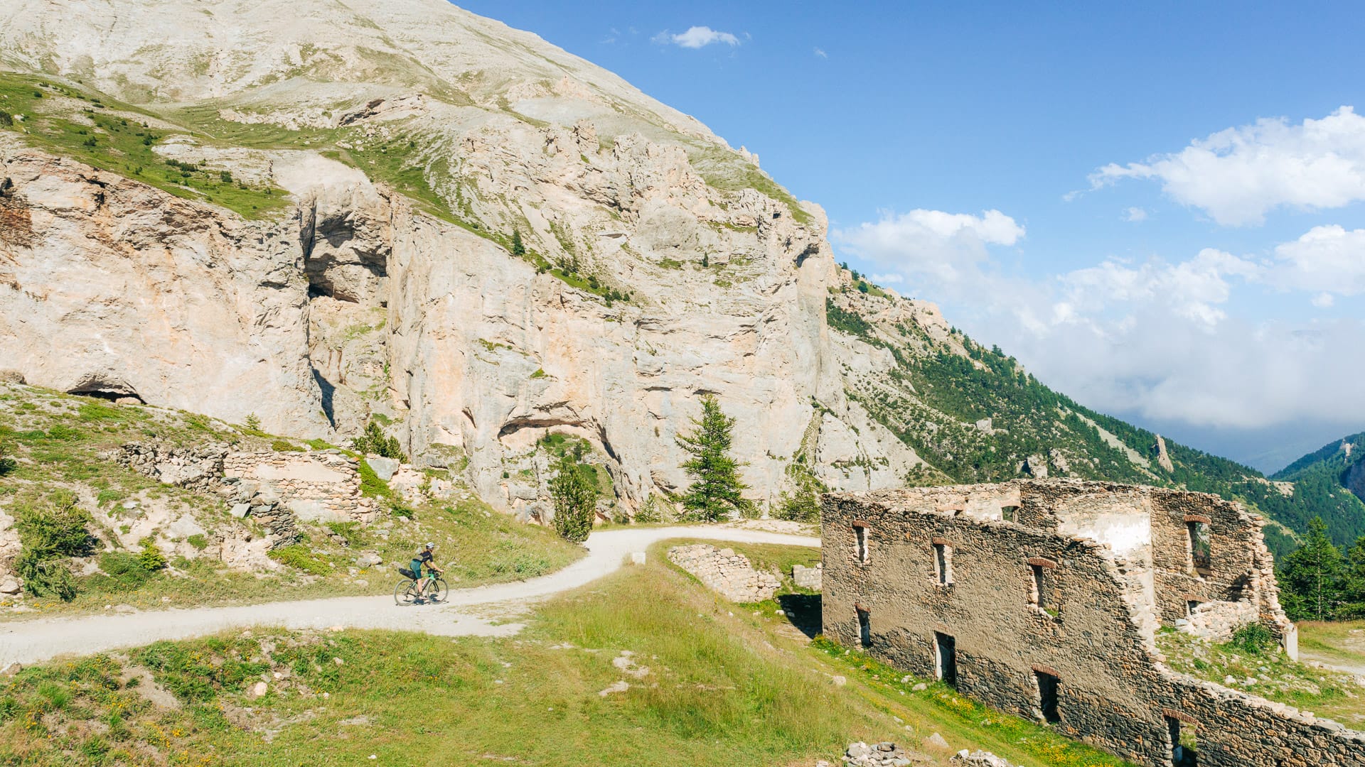 Cyclists riding along Strada del Pramand in the Piemonte mountains