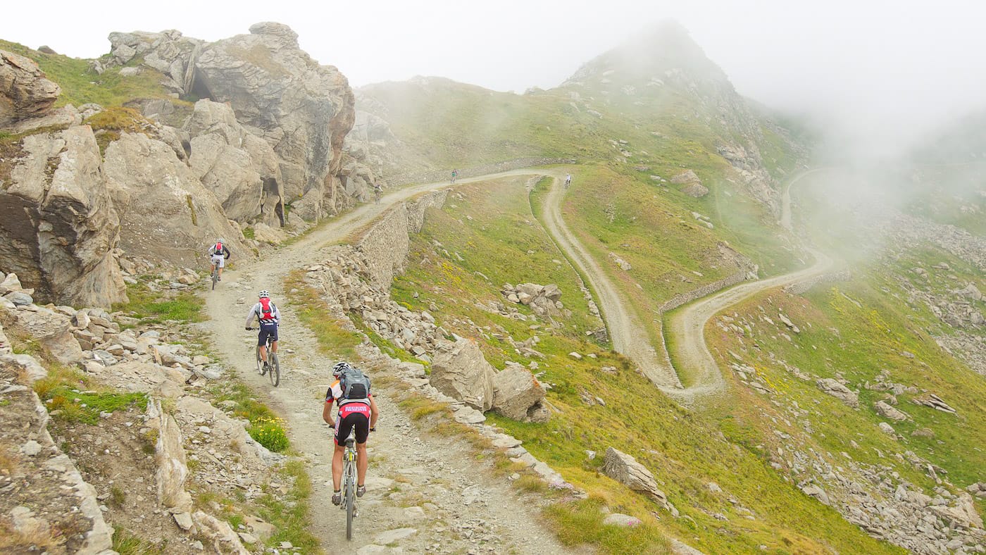 Cyclists riding through Usseaux during the Piemonte Super Giro event