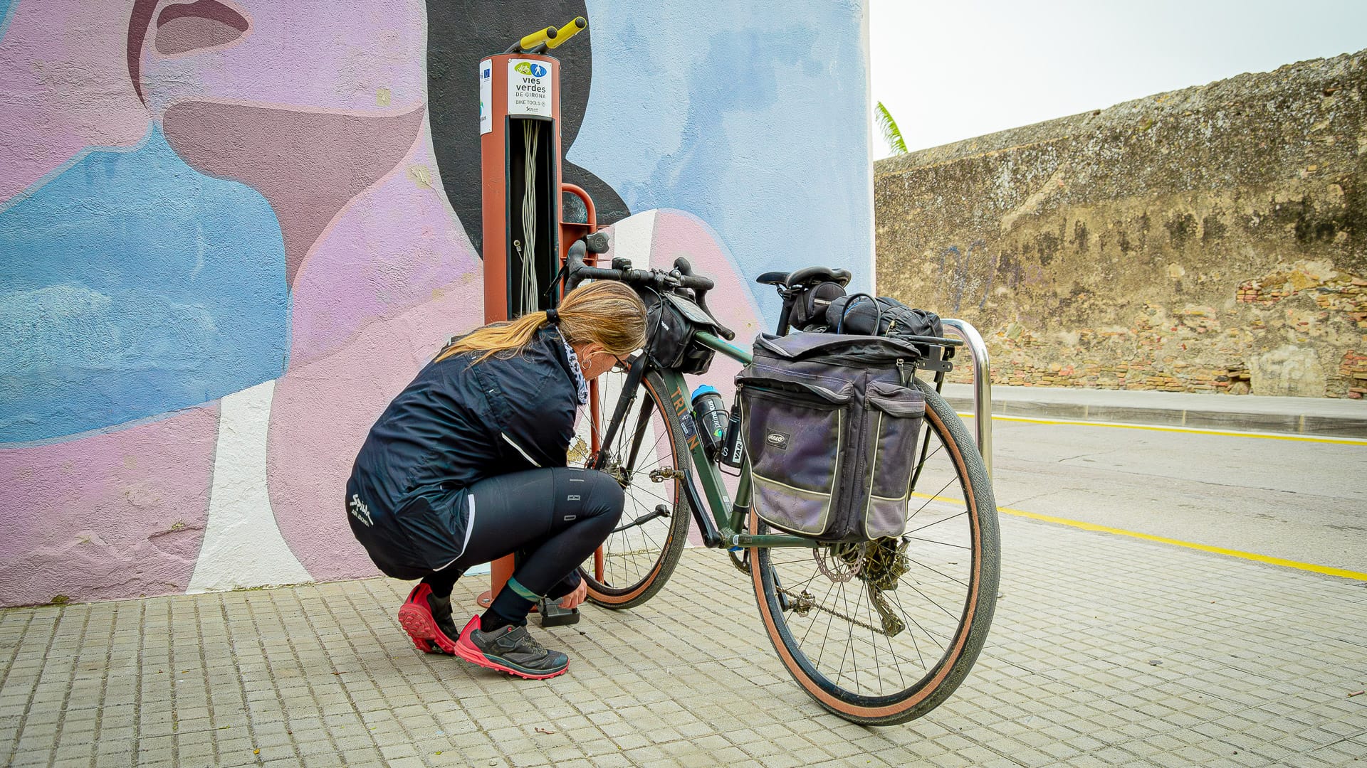 Cyclist inflating bike tyres in Castelló d’Empúries, Girona
