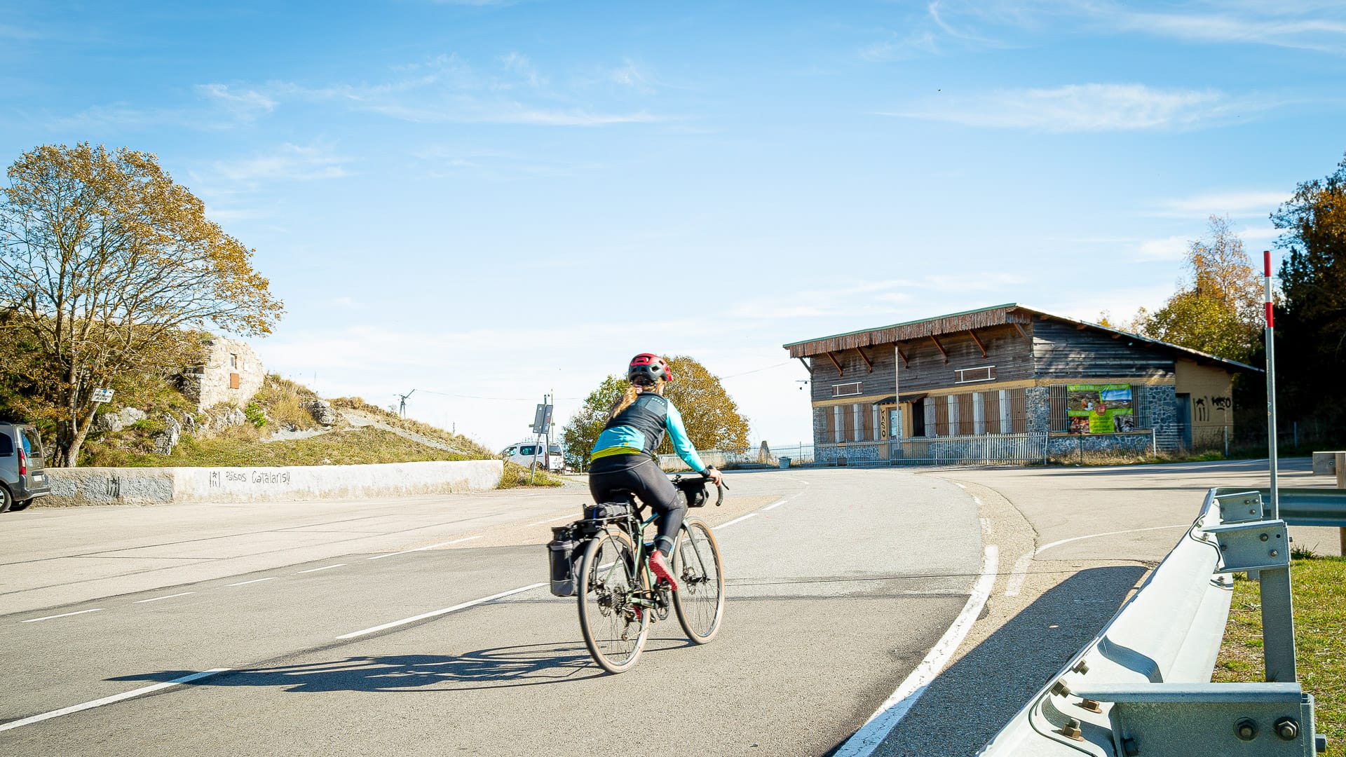 Cyclist climbing the smooth road on Coll d’Ares in the Girona Pyrenees
