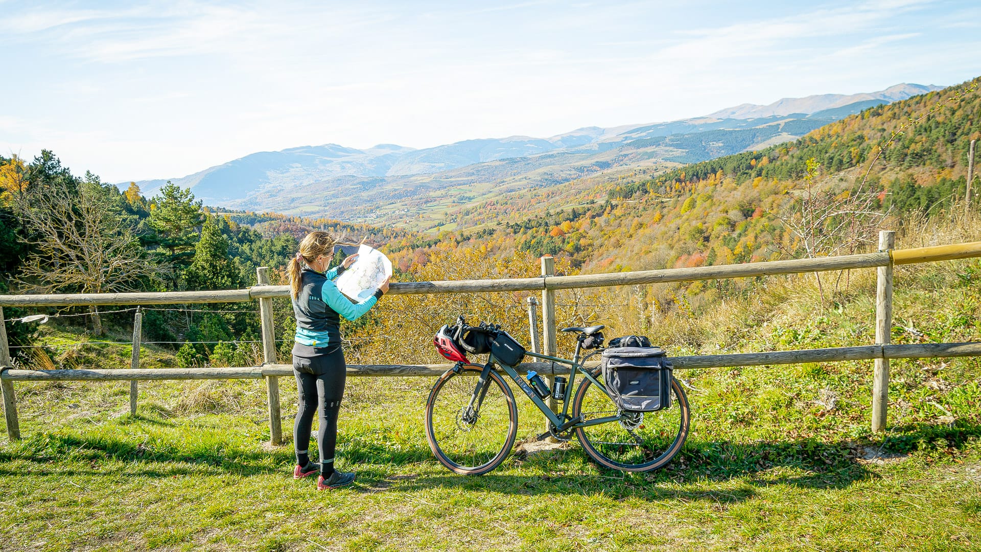 Cyclist checking the route map on Coll d’Ares in the Girona Pyrenees