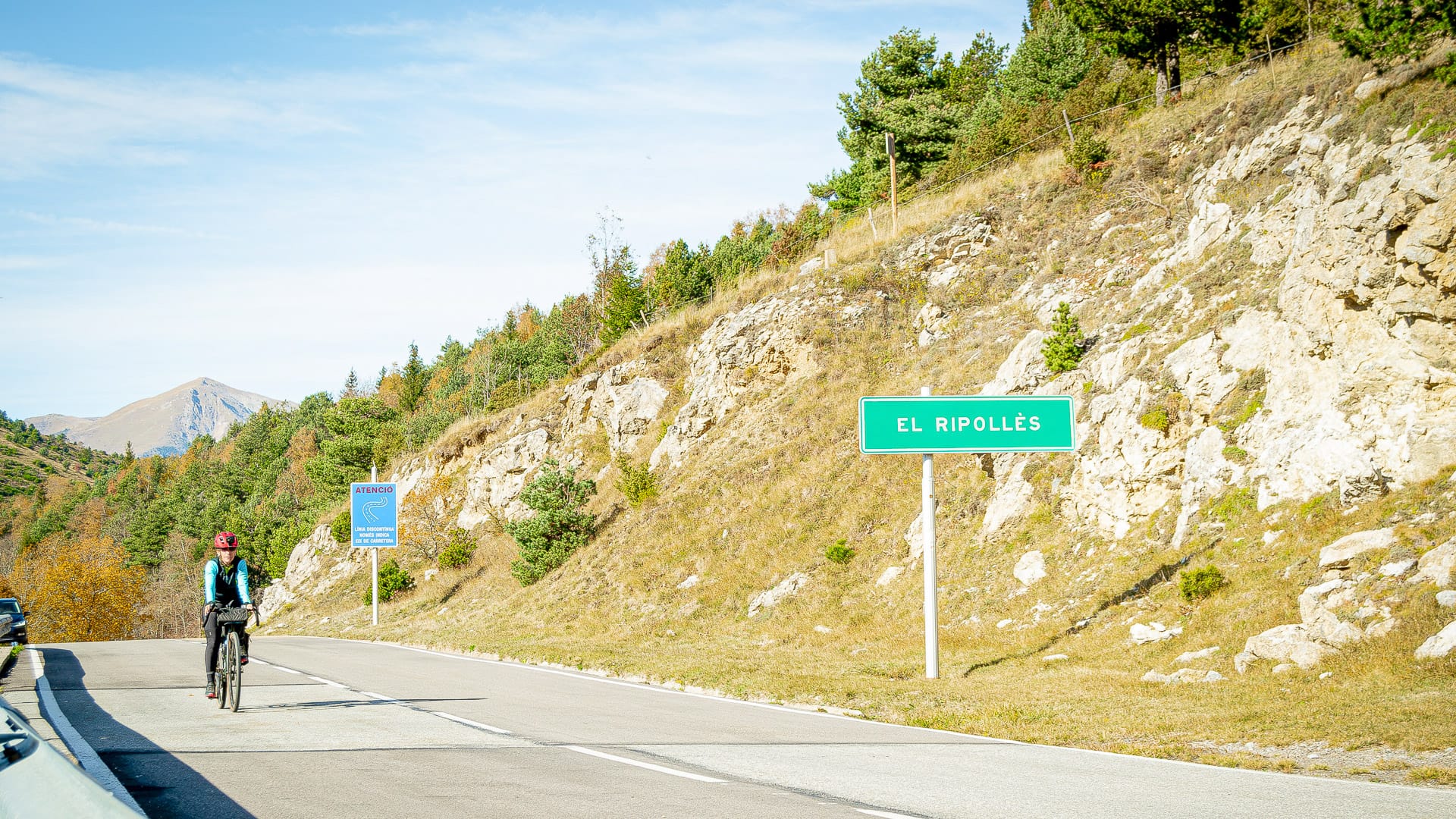 Cyclist following signposts on Coll d’Ares in the Girona Pyrenees