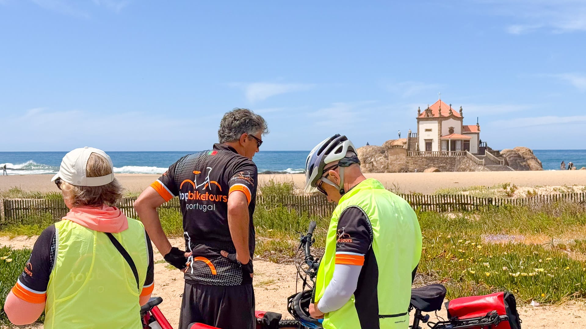 Cyclists stopping near the Capela do Senhor da Pedra, Miramar Beach