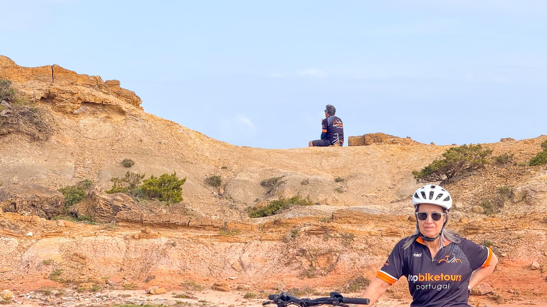 Cyclists passing by the Nazaré beach in Portugal