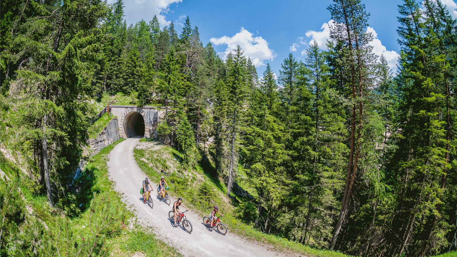 Cyclist descending the Cortina d'Ampezzo road in the Italian Dolomites