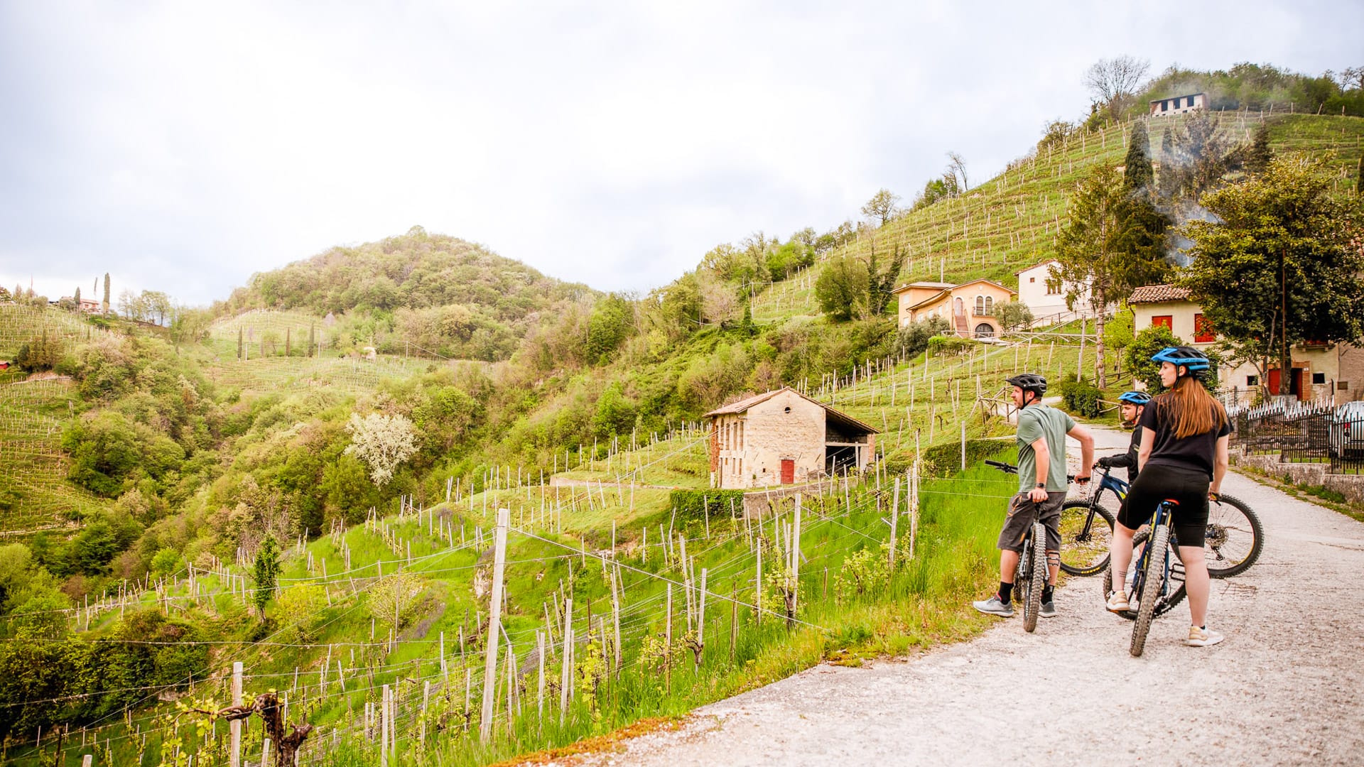 Cyclist on an e-bike taking a break at Collagù in the Prosecco Hills