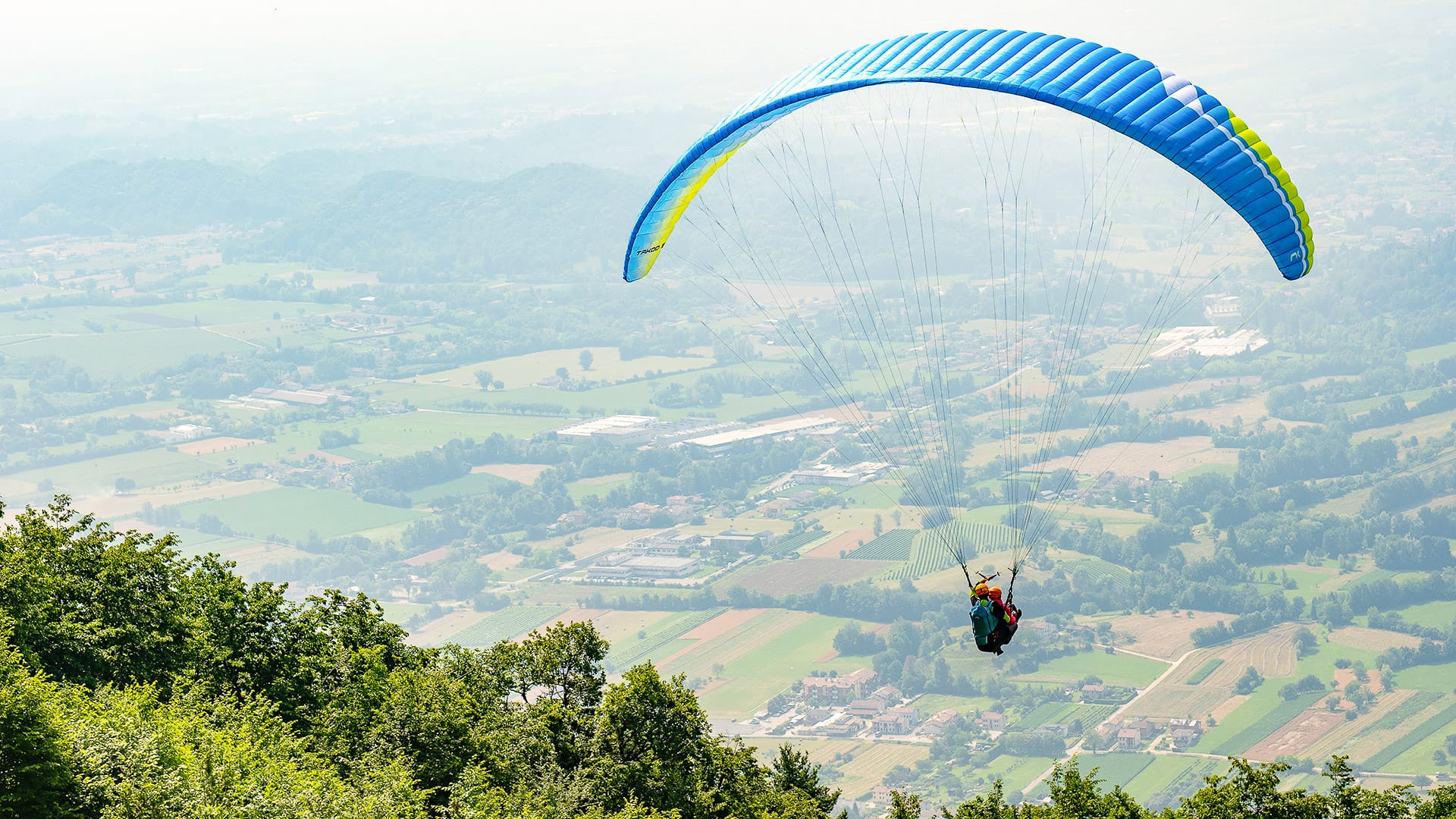 Paragliders launching from Borso del Grappa near Monte Grappa, Veneto, Italy