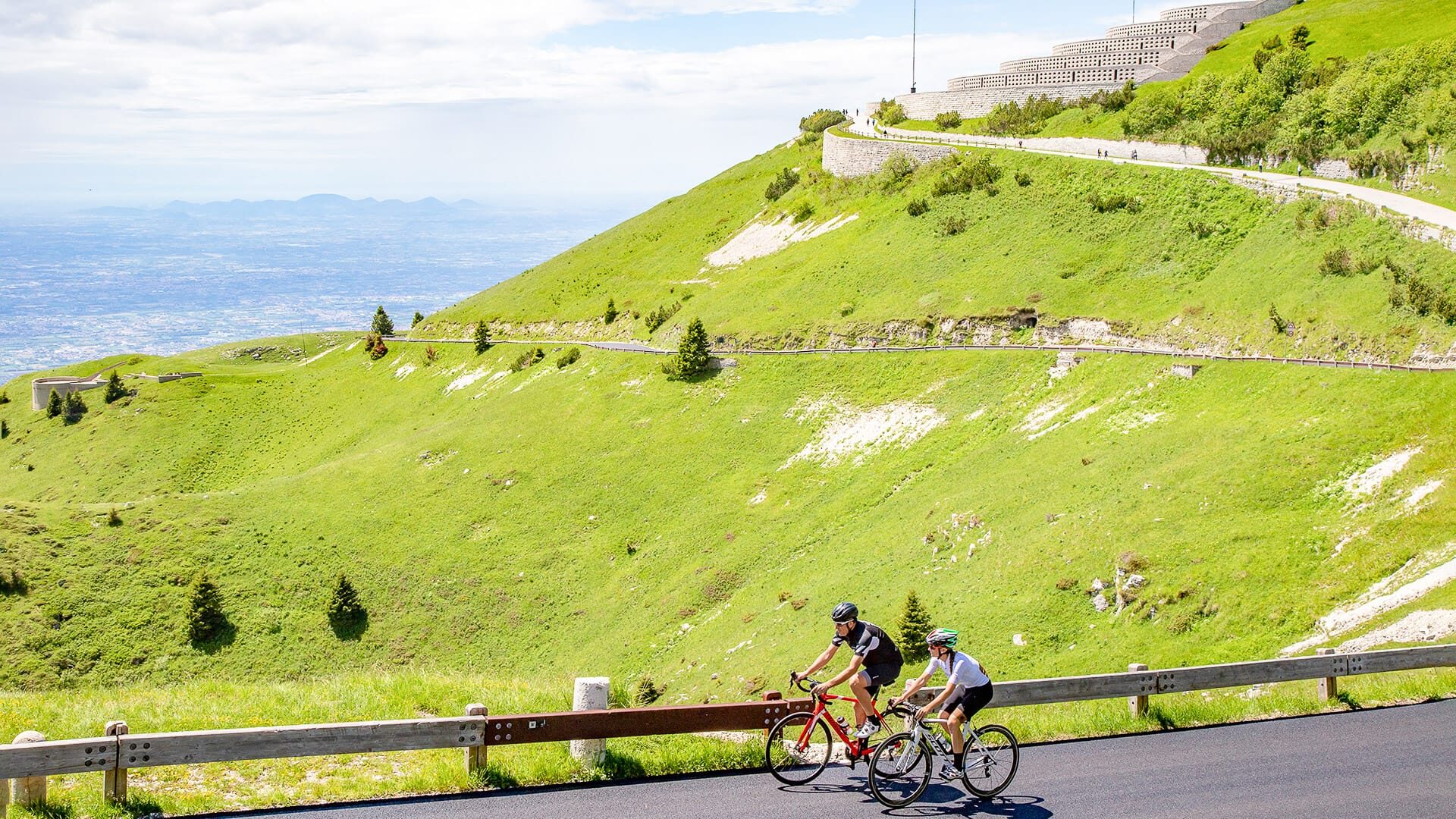 Road cyclists riding on Monte Grappa in the Prosecco Hills