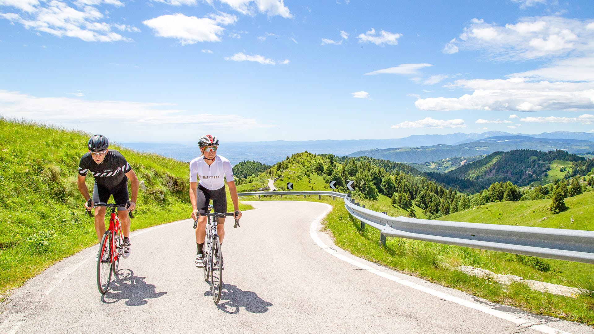 Road cyclists riding on Monte Grappa in Veneto, Italy