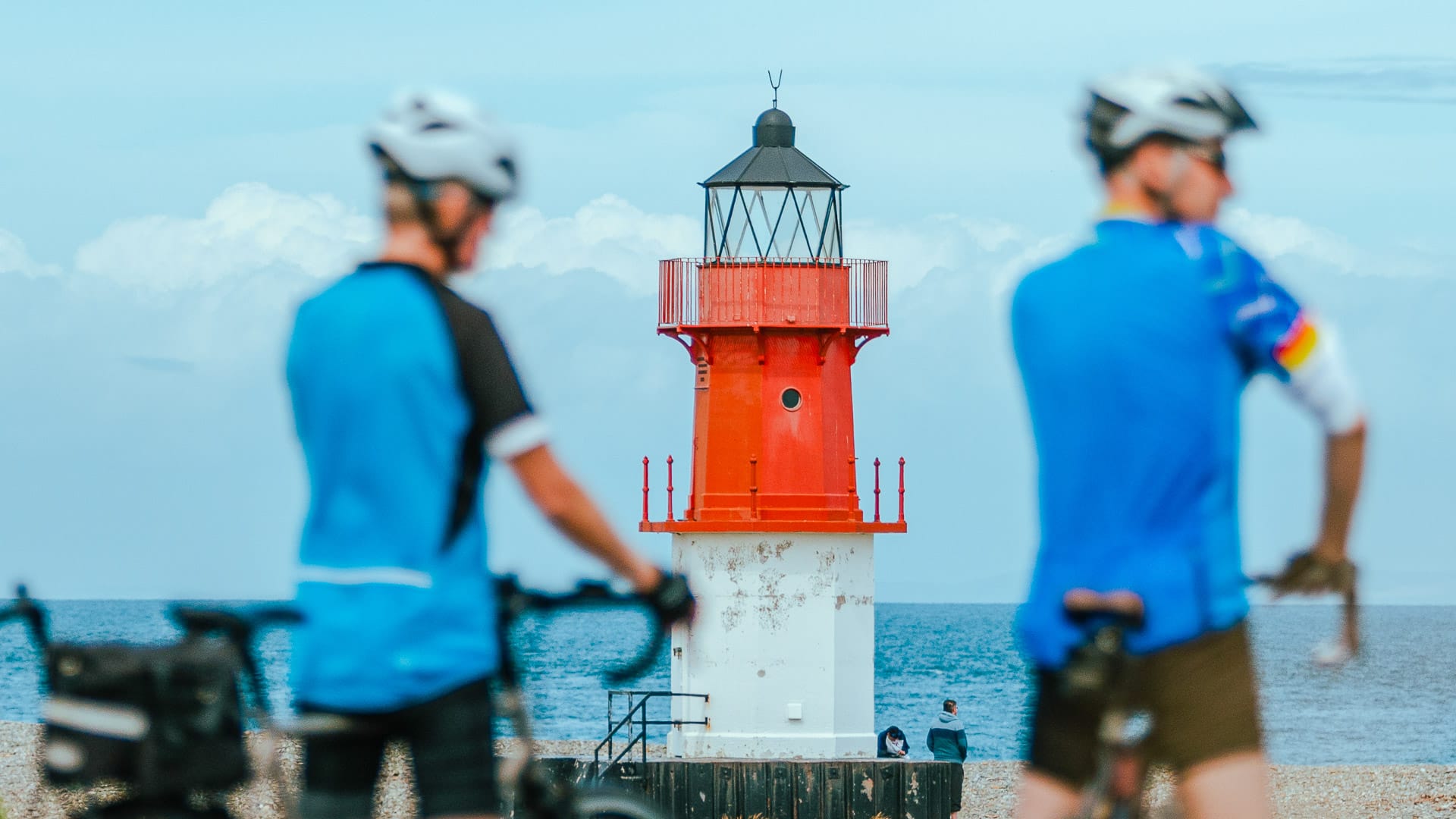 Cyclists at the Point of Ayre with the Winkie lighthouse in the background
