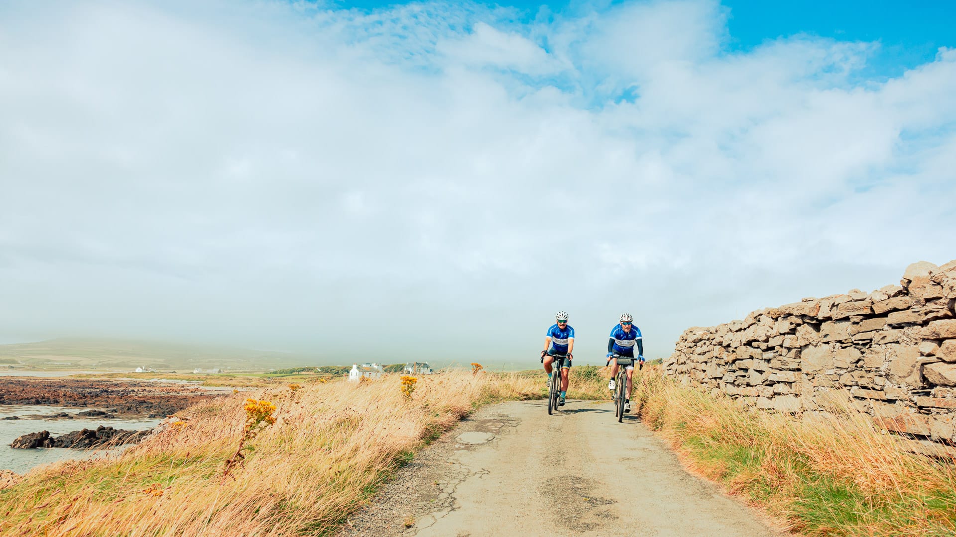 Cycling in the south of the Island, with Gansey Bay in the background