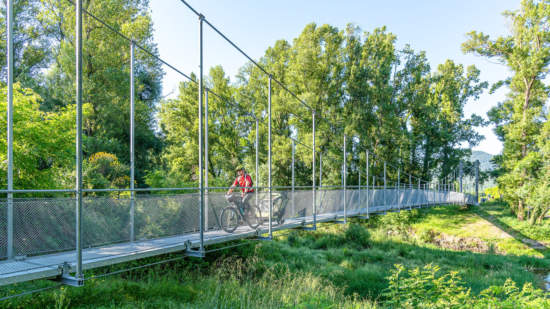 Passerelle himalayenne de Baix over the Rhône, with the suspended footbridge crossing the river