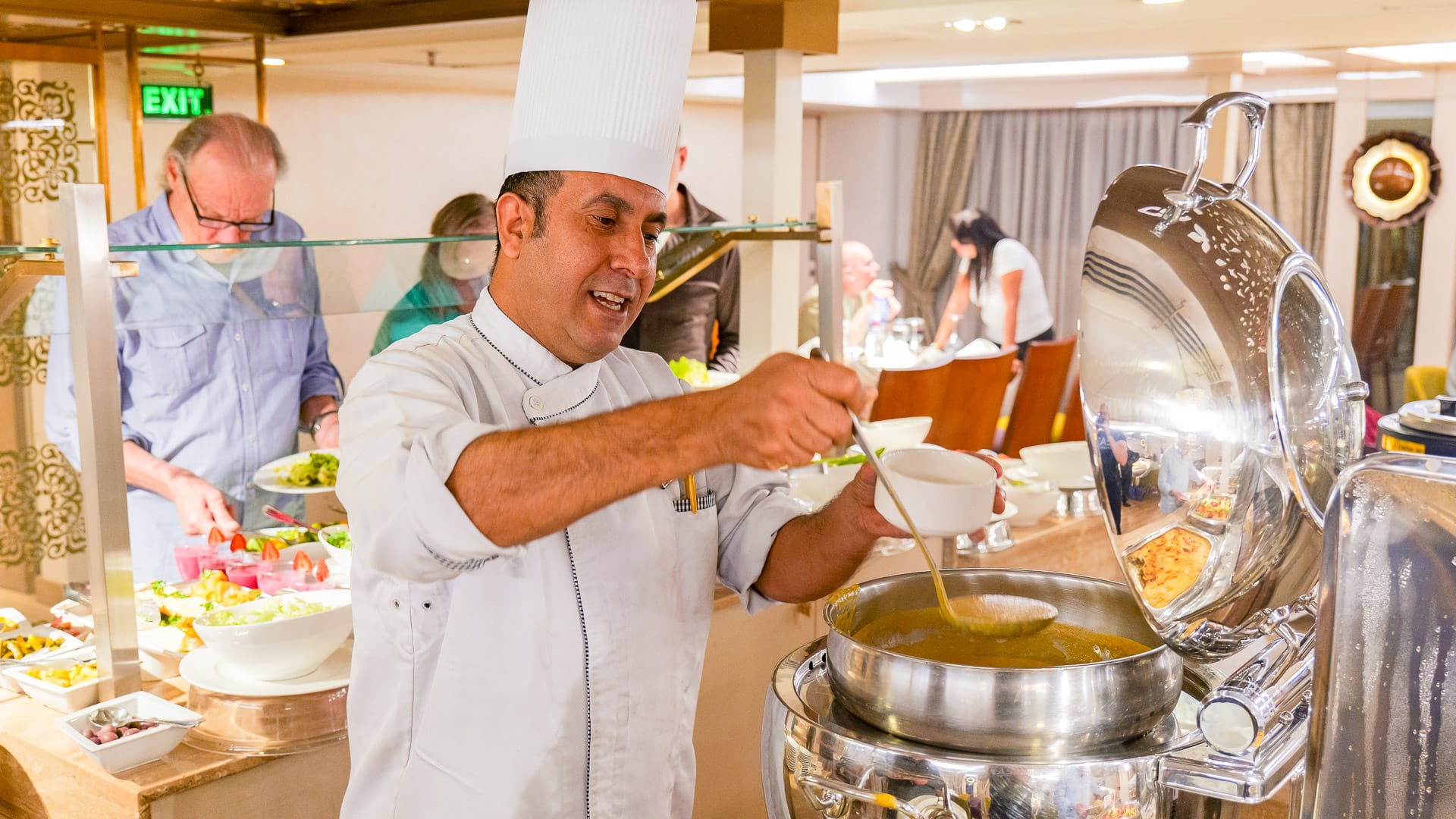 Chef pouring soup during dinner on board the Nebu during a Boat Bike Tours Egypt holiday