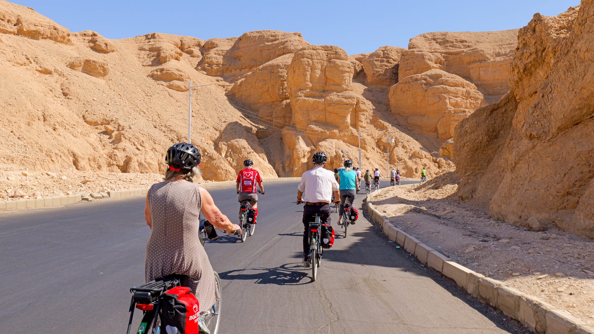Cyclists riding near the Valley of the Kings on a Boat Bike Tours Egypt holiday