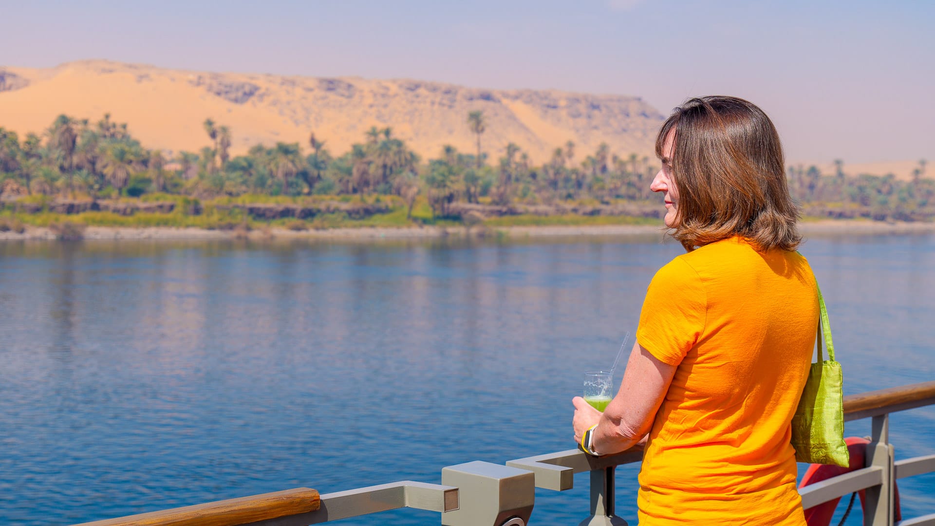 Guest looking out over the Nile from a Boat Bike Tours ship in Egypt