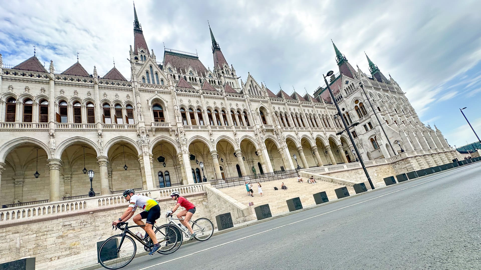 Cyclists in front of the Hungarian Parliament Building in Budapest