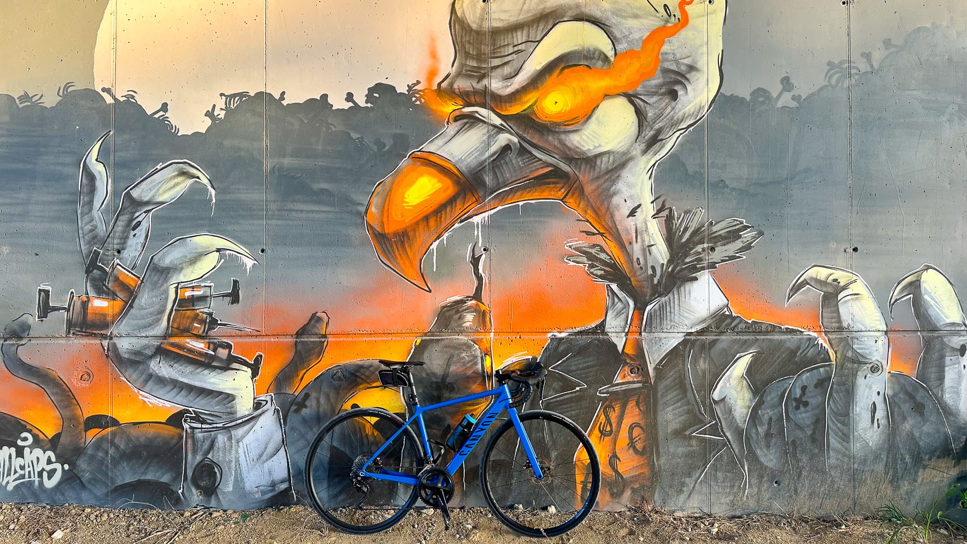 Bike parked in front of a painted wall during an urban gravel adventure in Budapest