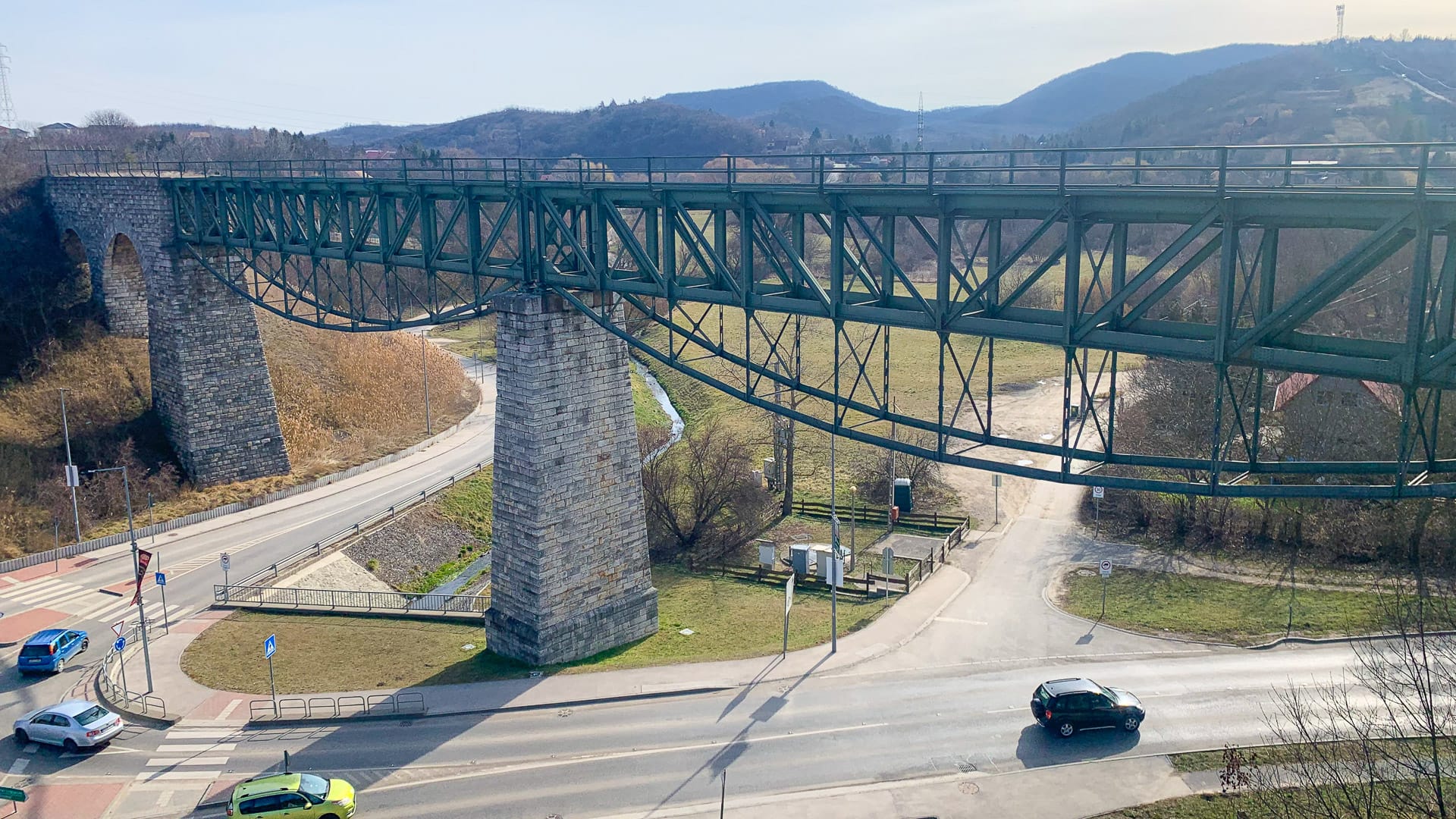 Cyclists crossing an old railway viaduct on the road to Etyek