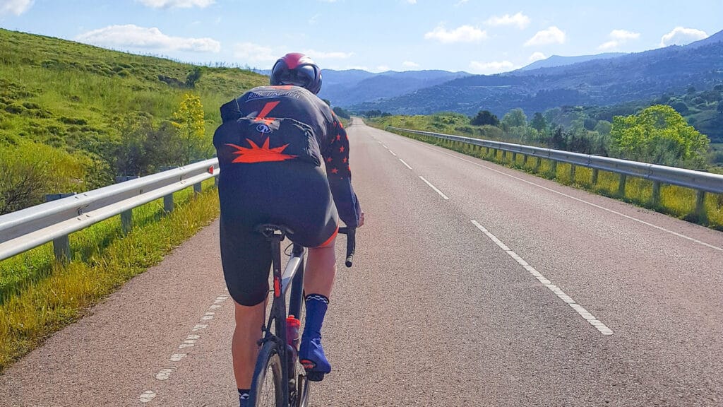 Road cyclist climbing Mount Olympus by road bike