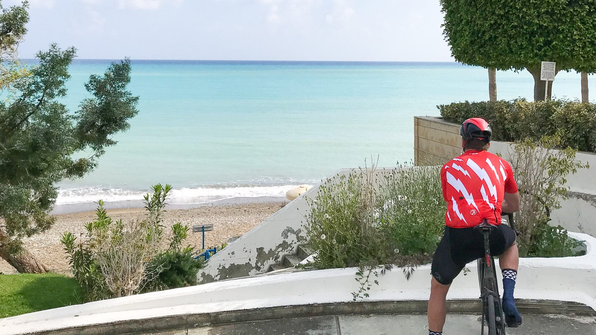Cycling to Pissouri Bay, Cyprus, road cyclist looking out to sea