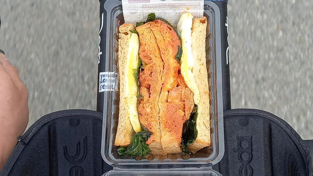 Bike with a sandwich secured to the front handlebars