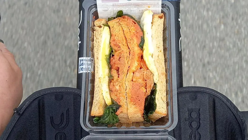 Bike with a sandwich secured to the front handlebars