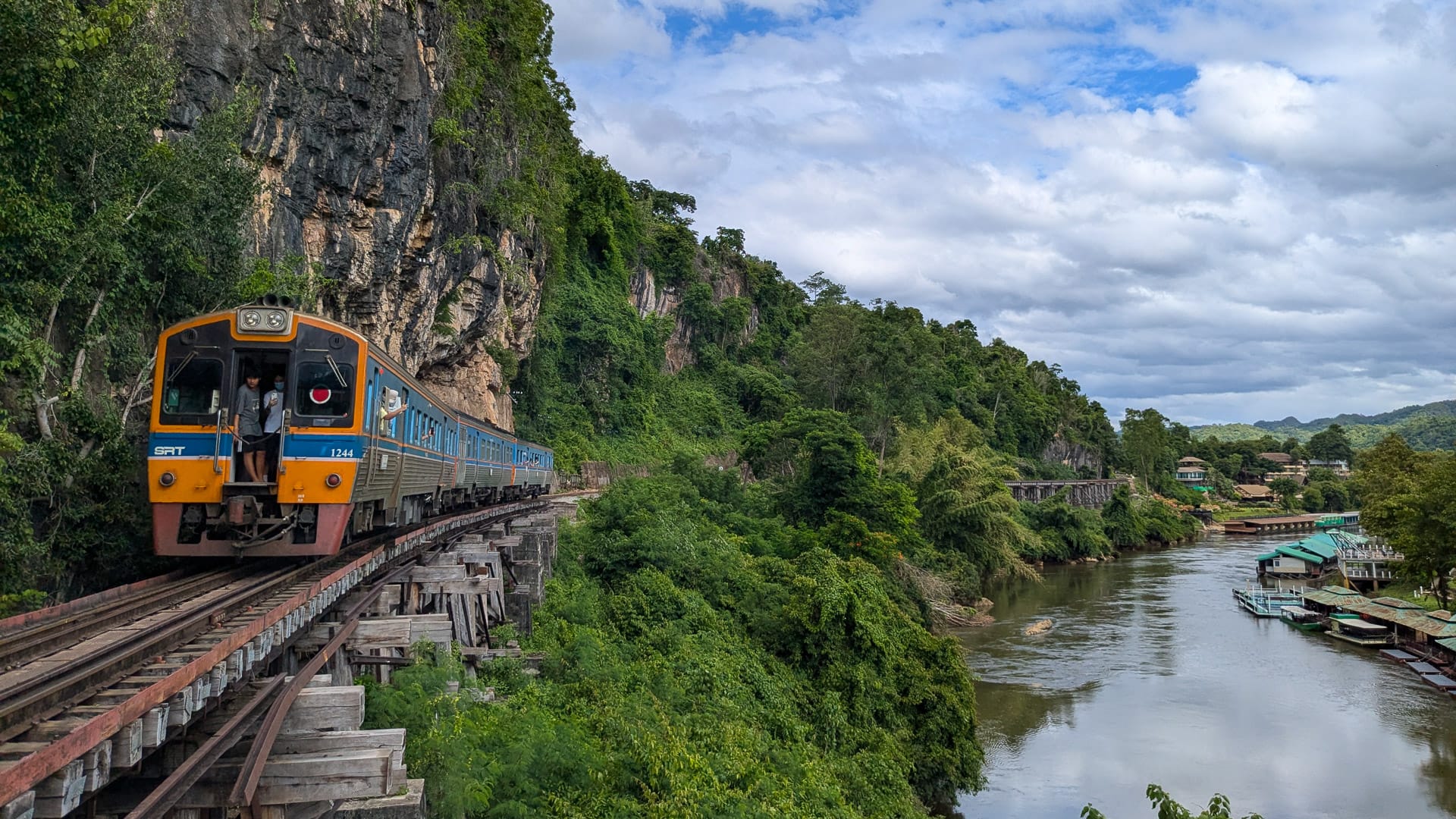 A train crossing the River Kwai in Kanchanaburi, seen during a cycling journey through western Thailand