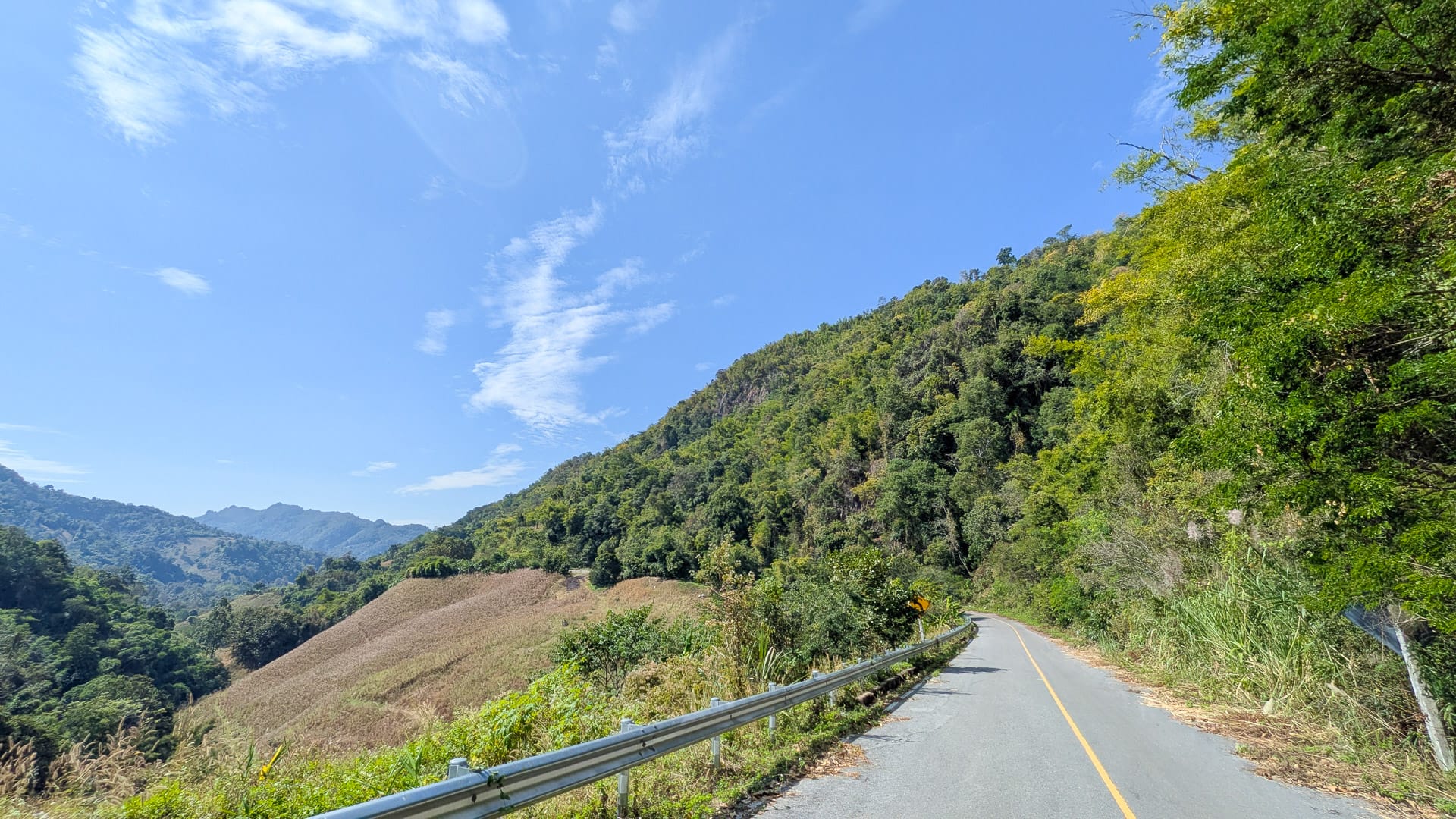 Cycling peaceful mountain roads in Phrae, surrounded by the quiet landscapes of northern Thailand