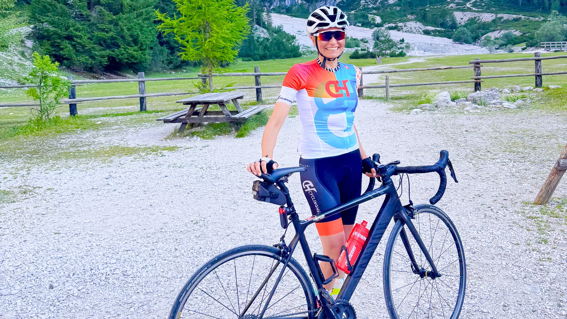 Cyclist stopping to take a photo on a route through Fanes-Pederü in the Dolomites