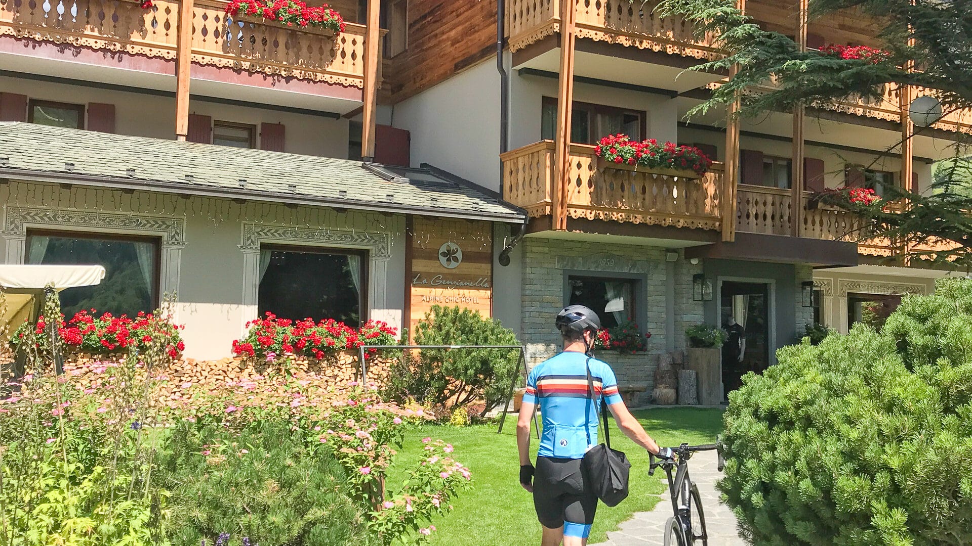 Cycling walking into a cycling hotel in Italy