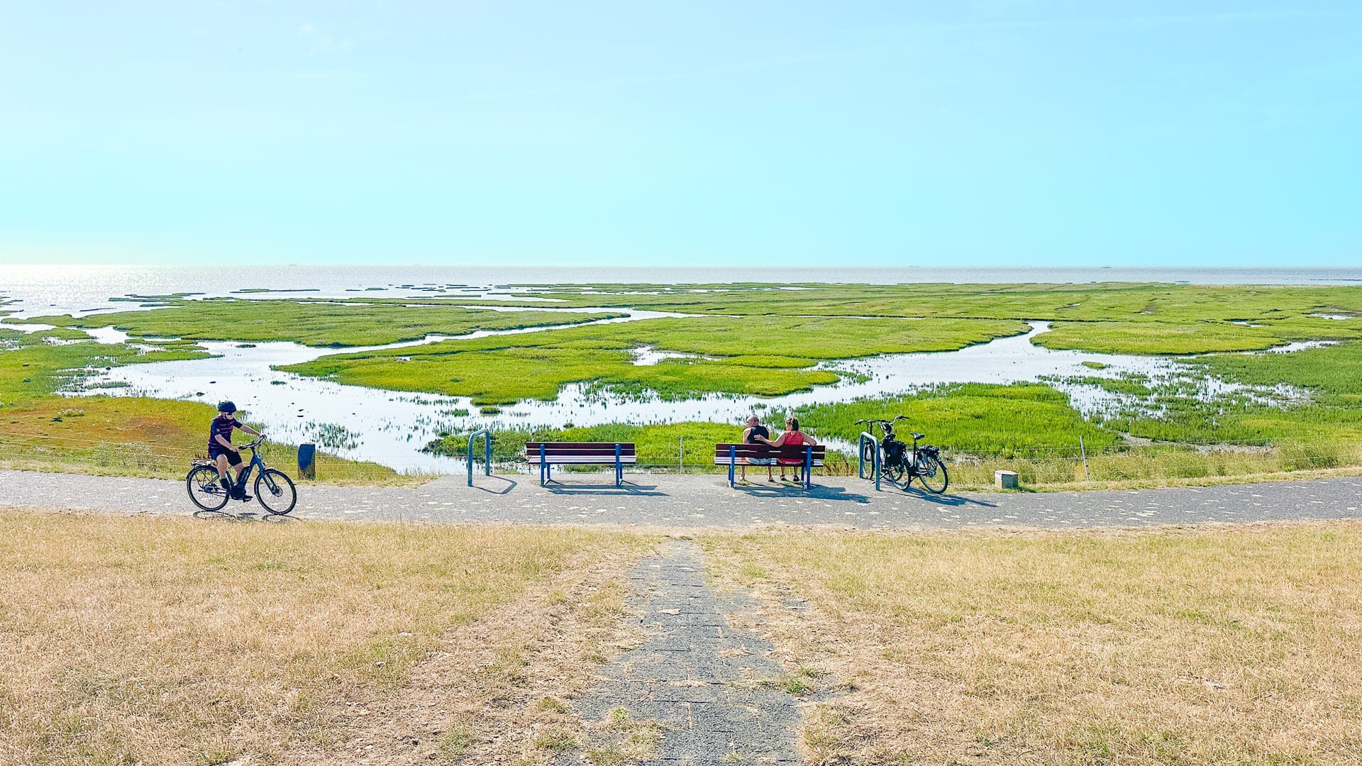 Cycling past resting cyclists in Friesland
