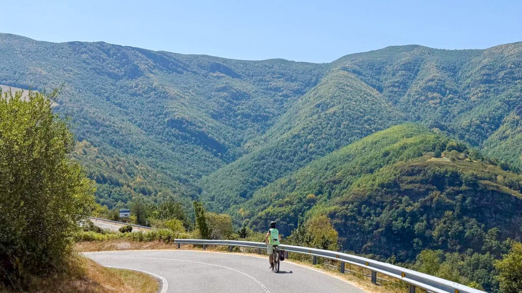 Cyclists riding through hills on the Camino Francés