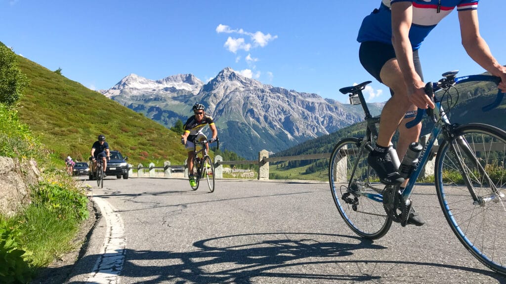 Cyclists riding through Splügen in Graubünden, Switzerland